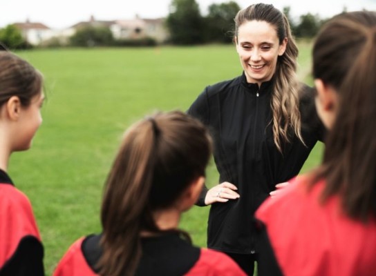 Sport coach with school students