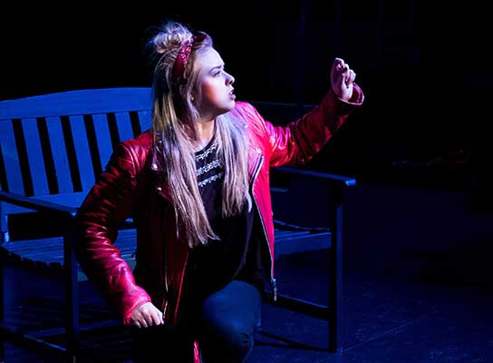 Female student performing on stage at Paston College