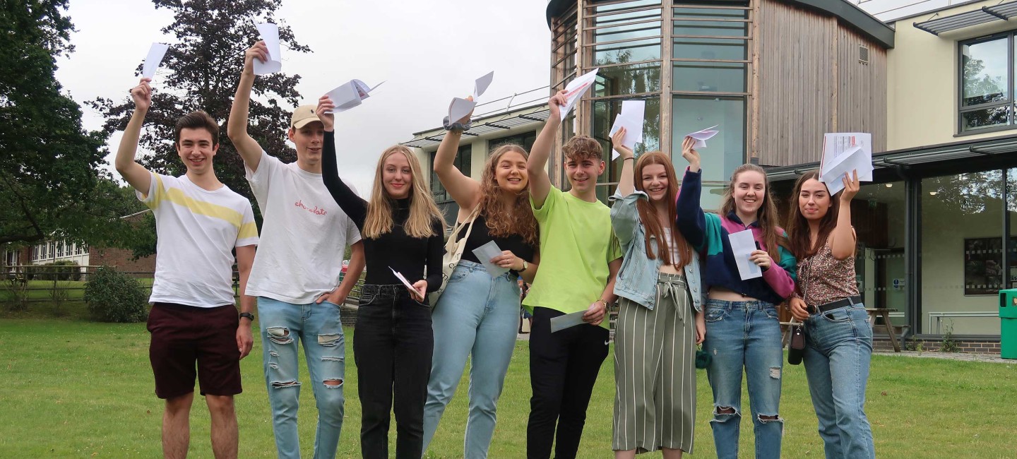 Group of students holding up A-level results on Lawns Campus