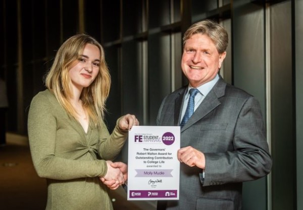 Molly Mudie receiving her Further Education award certificate from Andrew Barnes Chair of Governors City College Norwich CREDIT DAVID KIRKHAM 1
