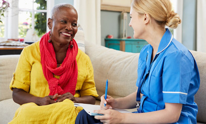 Nurse talking to patient in their home