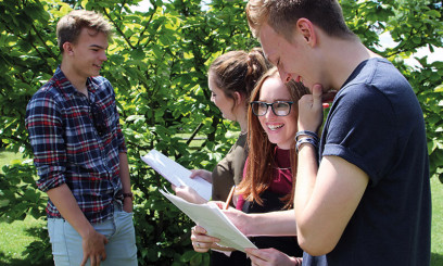 Students outside with A-level results